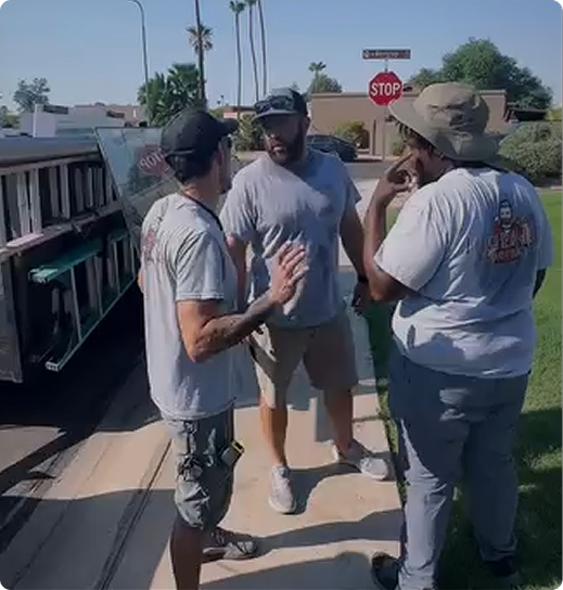 Three crew members discussing project details on-site