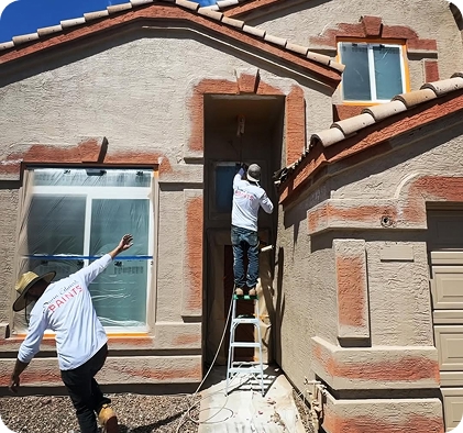 Painting crew working on stucco home exterior